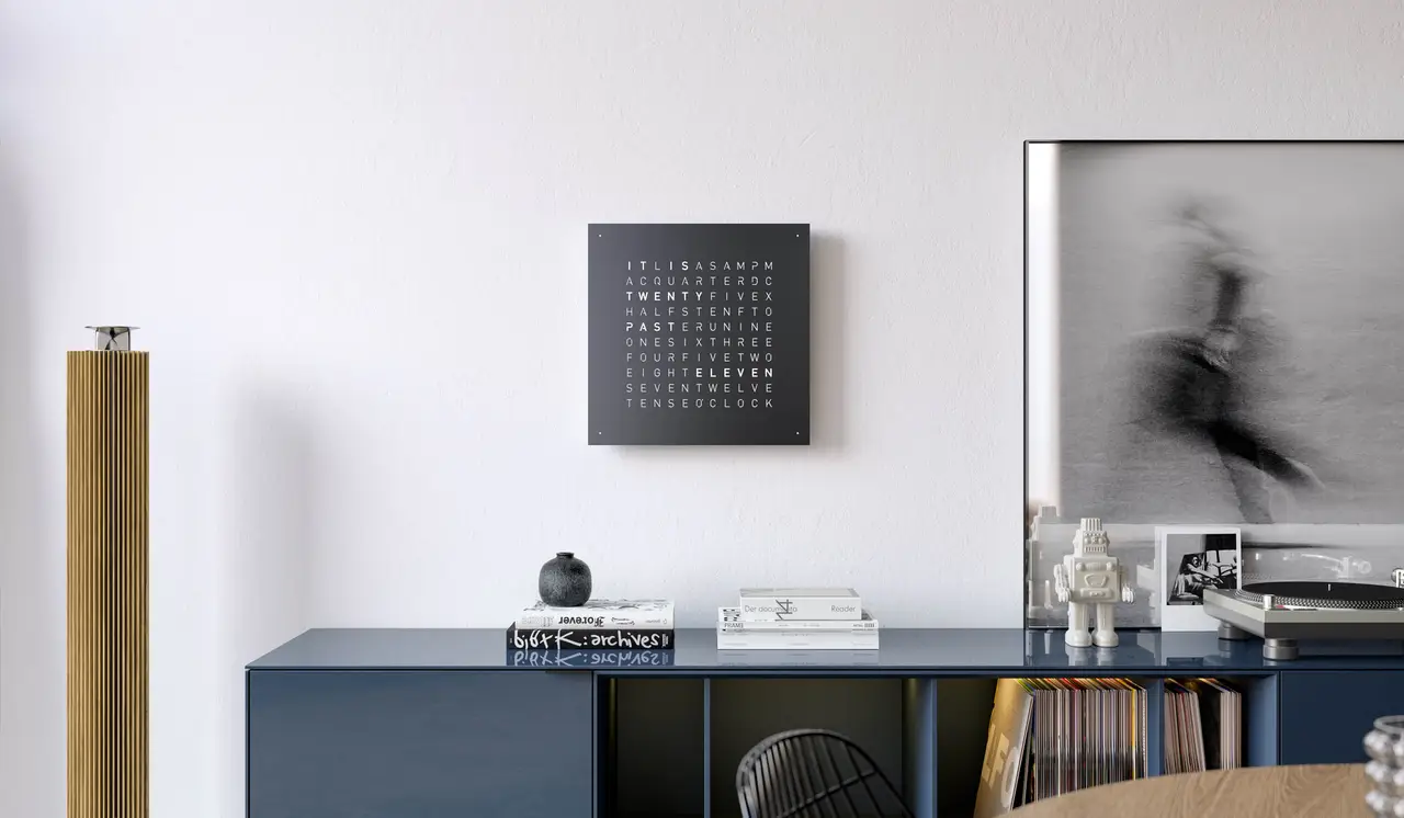 QLOCKTWO EARTH 45 Black Pepper word clock with black finish displayed in a modern living room